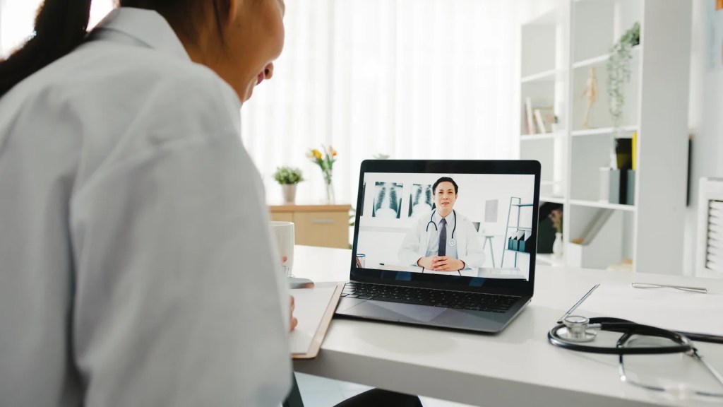 Doctor on a video call at a laptop